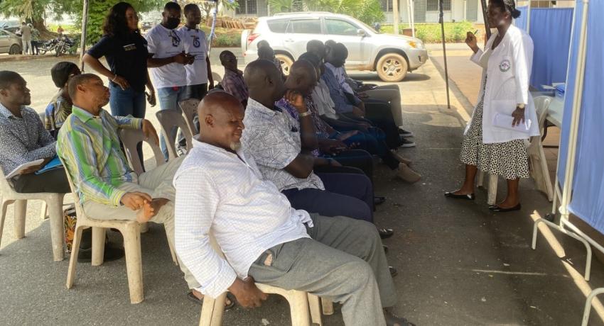 Public Health Officer addressing the men